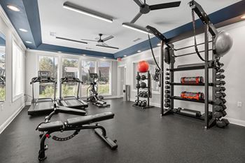 A spacious home gym with a variety of exercise equipment.